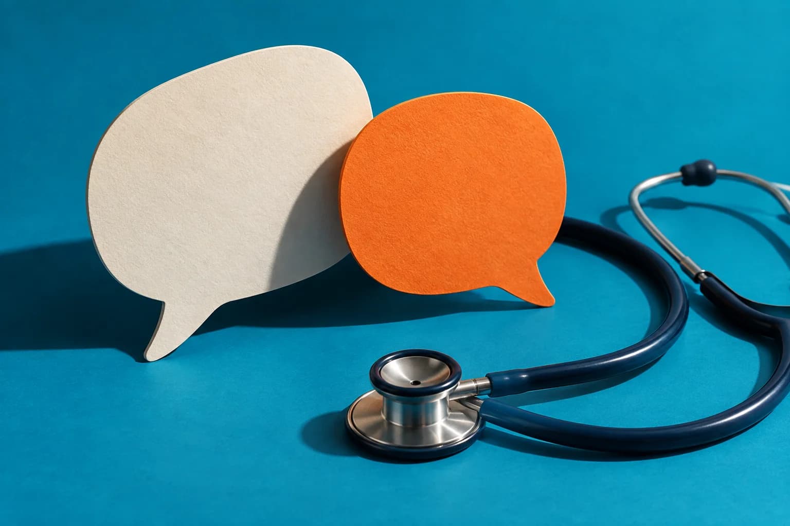 Concept image : Paper speech bubbles and a stethoscope against teal
